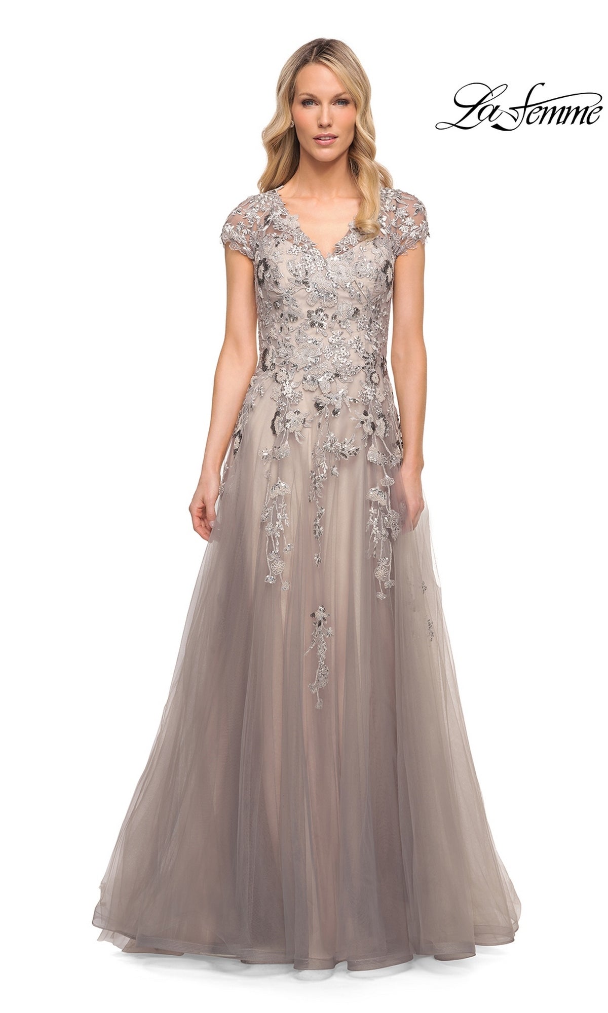 The La Femme 30239 is a floor-length, taupe mother of the bride dress featuring a V-neckline, cap sleeves, and silver floral embroidery embellishing the tulle A-line bodice and waist.